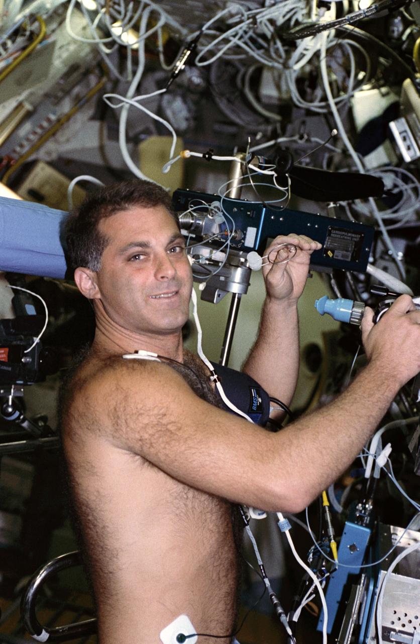 STS058-204-014 (18 Oct.-1 Nov. 1993) --- Astronaut David A. Wolf, mission specialist, participates in an experiment that investigates in-space distribution and movement of blood and gas in the pulmonary system.  The data gathered during the two-week flight will be compared with results of tests performed on Earth to determine the changes that occur in pulmonary functions. Photo credit: NASA
