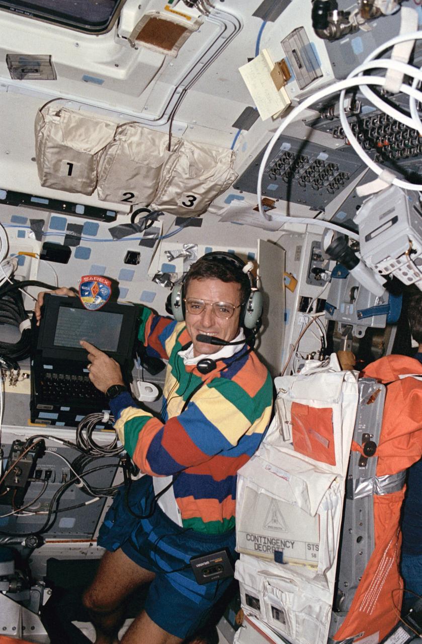 STS058-21-011 (24 Oct 1993) --- From the flight deck of the Earth-orbiting Space Shuttle Columbia, astronaut William S. McArthur talks to students on Earth.  The mission specialist's activity was part of the Shuttle Amateur Radio Experiment (SAREX), a frequent payload on Shuttle missions which serves to enlighten students around the world on the topic of space travel.  McArthur (call letters KC5ACR) is one of three licensed amateur radio operators on the seven-member flight.