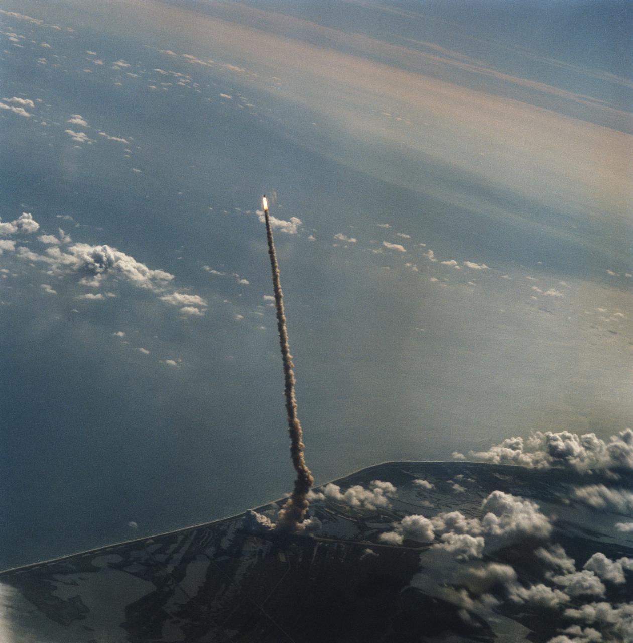 STS058-S-122 (18 Oct 1993) --- This distant shot of Columbia on its way to Earth-orbit was captured on film from the Shuttle Training Aircraft (STA) assigned to advance launch range screening.  Onboard the spacecraft were six NASA astronauts, a veterinarian from the private sector and the Spacelab Life Sciences (SLS-2) science module.  The crew will spend two weeks in Earth-orbiting devoting all its on-duty time to life sciences research.  Launch occurred at 10:53 a.m. (EDT), October 18, 1993, from the Kennedy Space Center (KSC).