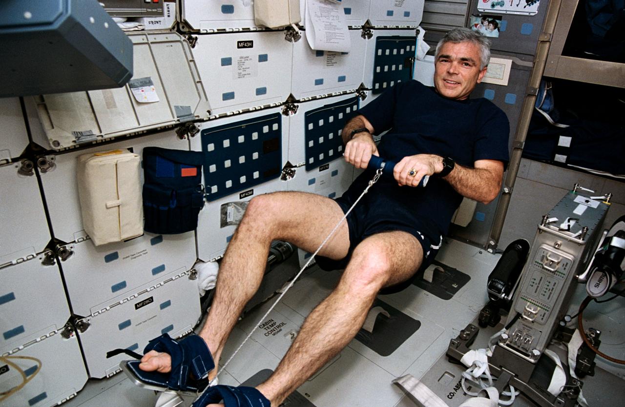 STS059-11-014 (9-20 April 1994) --- Astronaut Michael R. (Rich) Clifford, mission specialist, uses the rowing machine temporarily deployed on the Space Shuttle Endeavour's middeck.  Many of the crew members put in time on the device during the week and a half mission.
