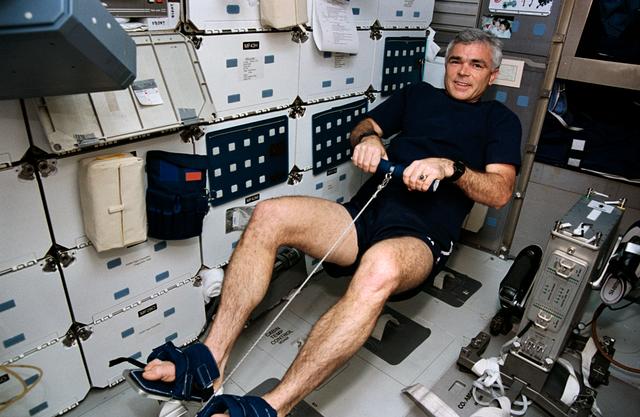 NASA image: Crewmember in the middeck exercising on the MK-1 rowing machine (DTO 653).