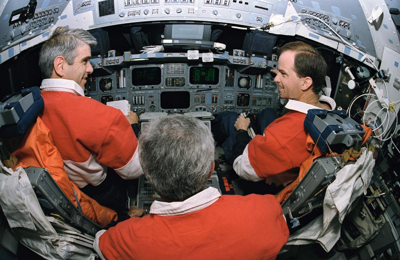 STS059-12-035 (9-20 April 1994) --- A 16mm lens on a 35mm camera provides a "fish-eye" effect for this rare scene on the Space Shuttle Endeavour's flight deck during checkout of the spacecraft's flight control systems.  Astronauts Sidney M. Gutierrez (left) and Kevin P. Chilton (right) man the commander and pilot stations, respectively.  Astronaut Michael R. (Rich) Clifford, the flight engineer, is seated behind the two.  Not pictured are astronauts Linda M. Godwin, payload commander, and Jerome (Jay) Apt and Thomas D. Jones, both mission specialists.