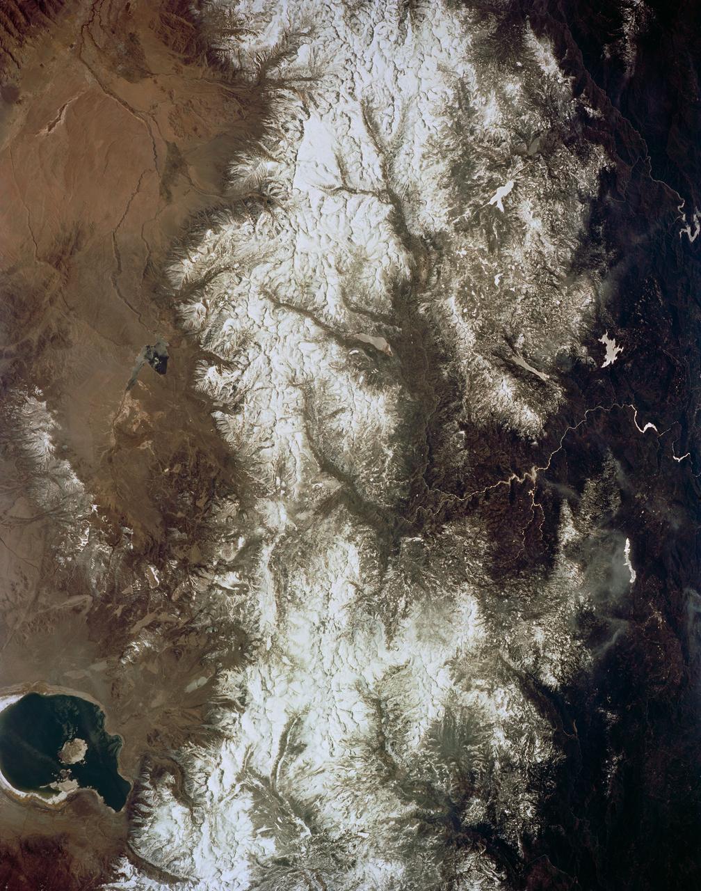 STS059-154-160 (9-20 April 1994) --- Orient with Mono Lake, California at the lower right; then the view is westward across the Sierra Nevada into the San Joaquin River drainage. A tiny network of ski trails can be seen on the Mono Lake side of the Sierras, on a line between Mono Lake and the snow-free San Joaquin headwaters. The ski trails mark Mammoth Mountain, where SRL investigators are studying microwave measurements of the water content of snowpacks. Linhof camera.