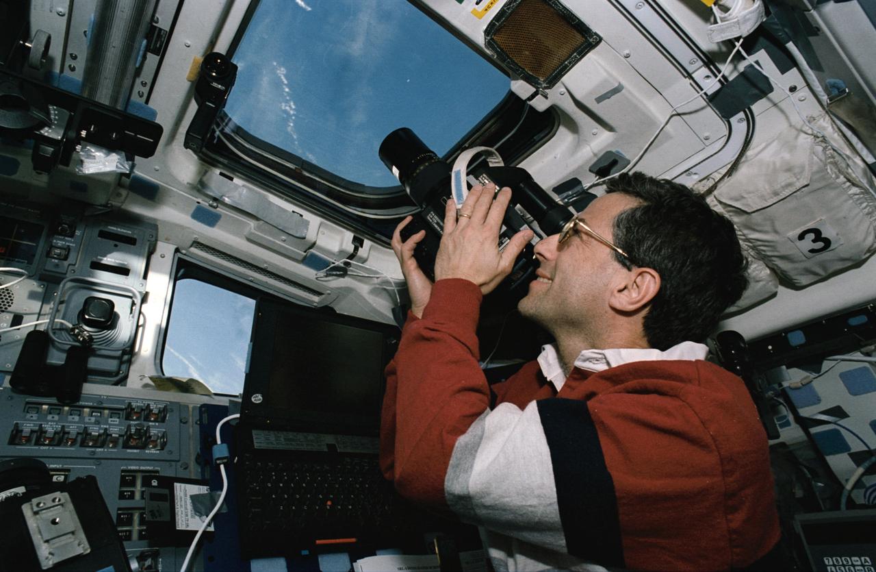 STS059-46-025 (9-20 April 1994) --- On the Space Shuttle Endeavour's aft flight deck astronaut Jerome (Jay) Apt, mission specialist, uses a handheld 70mm Hasselblad camera to record still scenes of Earth.  Apt, the commander of Endeavour's Blue Shift, joined five other NASA astronauts for a week and a half in space in support of the Space Radar Laboratory/STS-59 mission.