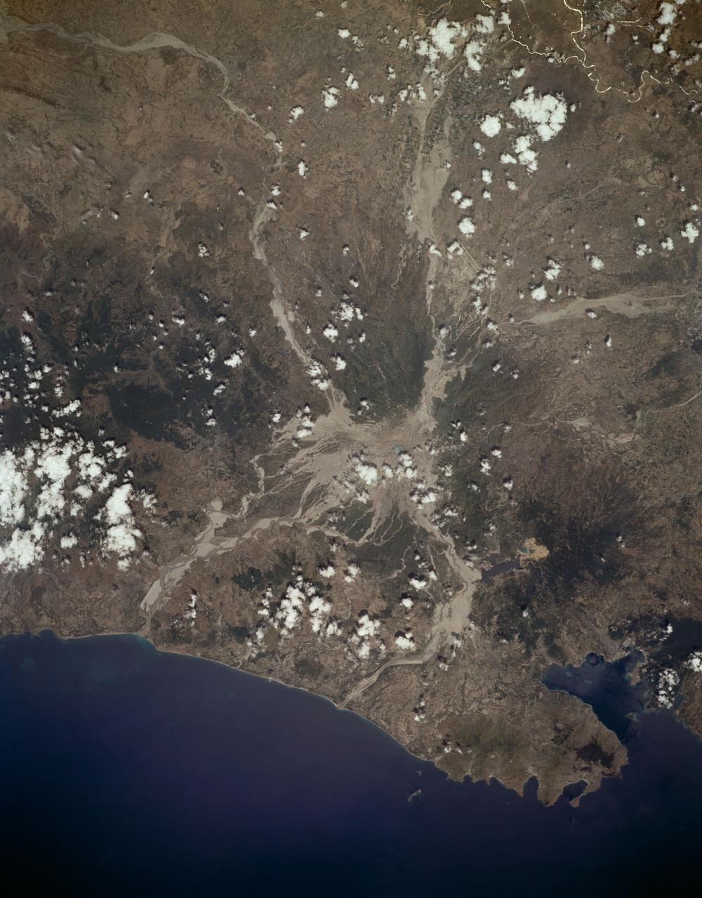 STS059-L14-170 (9-20 April 1994) --- Orient with the sea at the left.  Then Subic Bay is at the lower left corner, and Clark Air Force Base (abandoned after the eruption) is to the lower right of the volcano.  A turquoise lake occupies the caldera just below the center of the photograph.  Mount Pinatubo erupted in June, 1991 after several hundred years of quiescence.  Eruptive activity has nearly ceased, but every torrential rain in this monsoonal climate causes renewed mud flows of a viscous slurry composed of volcanic ash and pumice.  Shuttle crews have been photographing the mountain at every opportunity, to add documentation to unmanned-satellite, aerial, and ground-based observations of changes.  SRL scientists will use the excellent radar imagery obtained during STS-59 to help discriminate among different kinds of volcanic material, and to extend their observations to other volcanoes around the world using future, perhaps unmanned, radar satellites.  Linhof photograph.