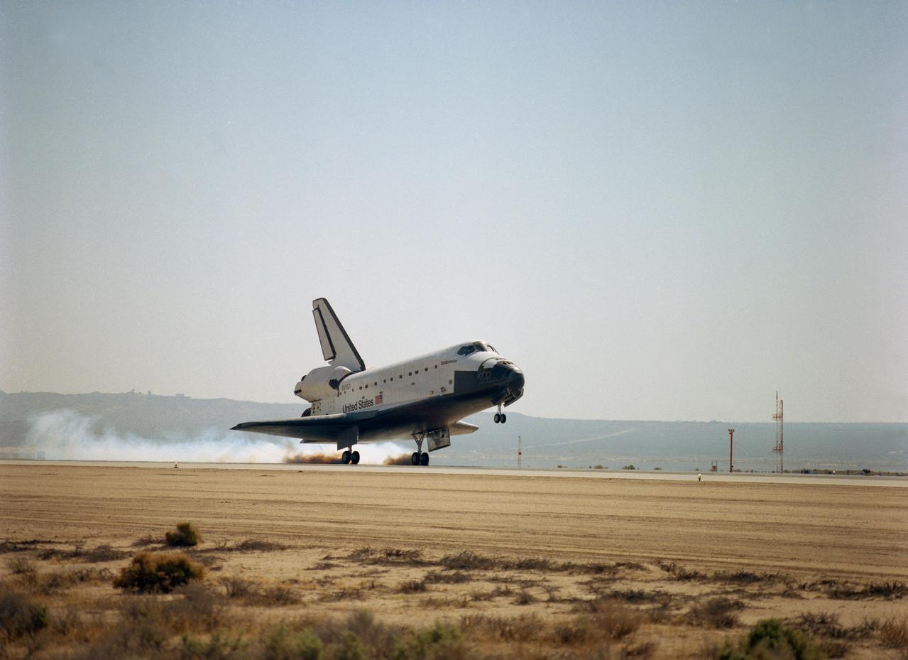 STS059-S-107 (20 April 1994) --- The main landing gear of the Space Shuttle Endeavour touches down at Edwards Air Force Base to complete the 11-day STS-59/SRL-1 mission.  Landing occurred at 9:54 a.m. (PDT), April 20, 1994.  Mission duration was 11 days, 5 hours, 49 minutes.  Guiding Endeavour to a landing was astronaut Sidney M. Gutierrez, STS-59 commander.  His crew was Kevin P. Chilton, Linda M. Godwin, Jerome (Jay) Apt, Michael R. (Rich) Clifford and Thomas D. Jones.