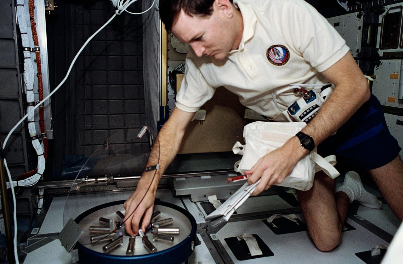 STS060-301-003 (3-11 Feb 1994) --- Astronaut Kenneth S. Reightler, STS-60 pilot, processes biomedical samples in a centrifuge aboard the SPACEHAB module.  Reightler joined four other NASA astronauts and a Russian cosmonaut for eight days of research aboard the Space Shuttle Discovery.