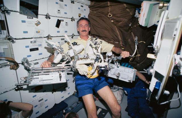 Astronaut Jeffrey Hoffman displays tools for use on HST