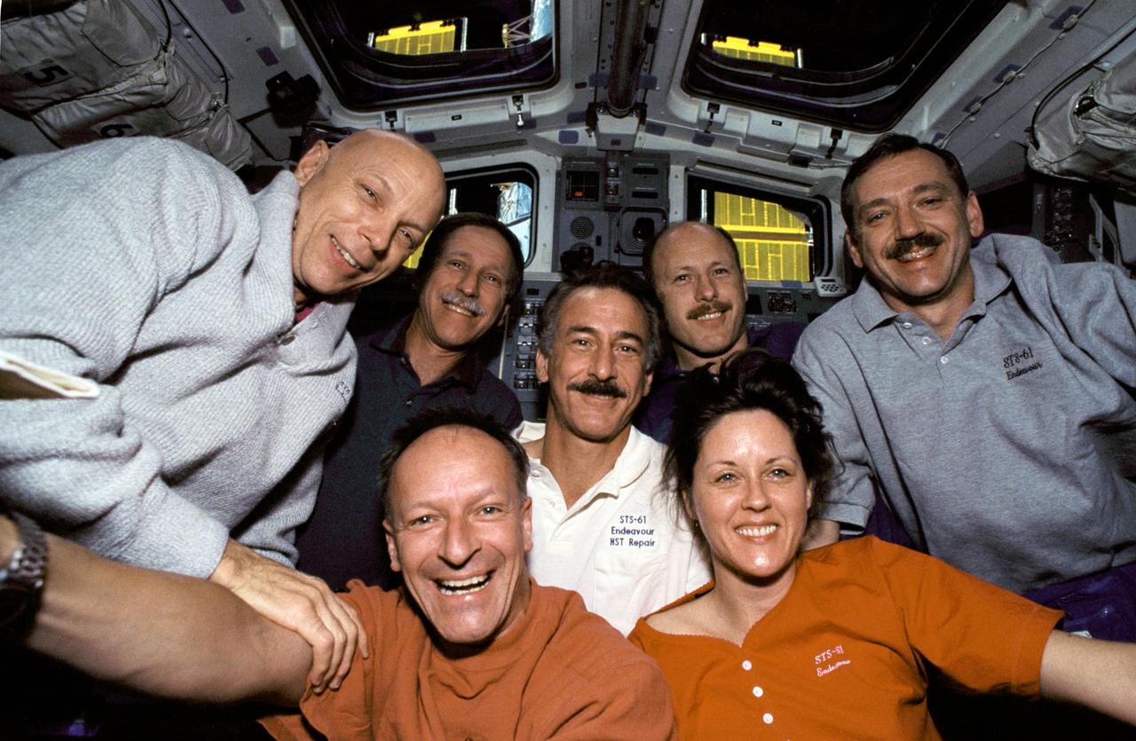 STS061-05-031 (2-13 Dec 1993) --- With the Hubble Space Telescope (HST) berthed in Endeavour's cargo bay, crew members for the STS-61 mission pause for a crew portrait on the flight deck.  Left to right are F. Story Musgrave, Richard O. Covey, Claude Nicollier, Jeffrey A. Hoffman, Kenneth D. Bowersox, Kathryn C. Thornton and Thomas D. Akers.