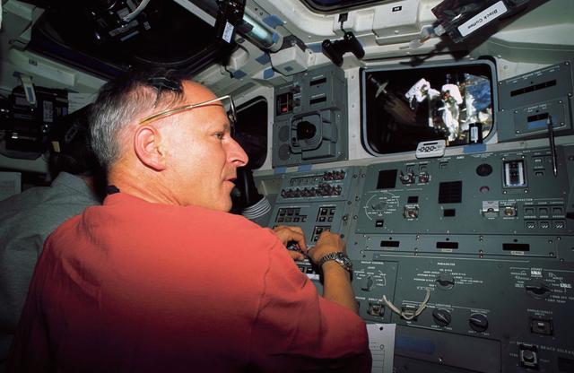 NASA image: Astronaut Claude Nicollier on flight deck at controls of the RMS