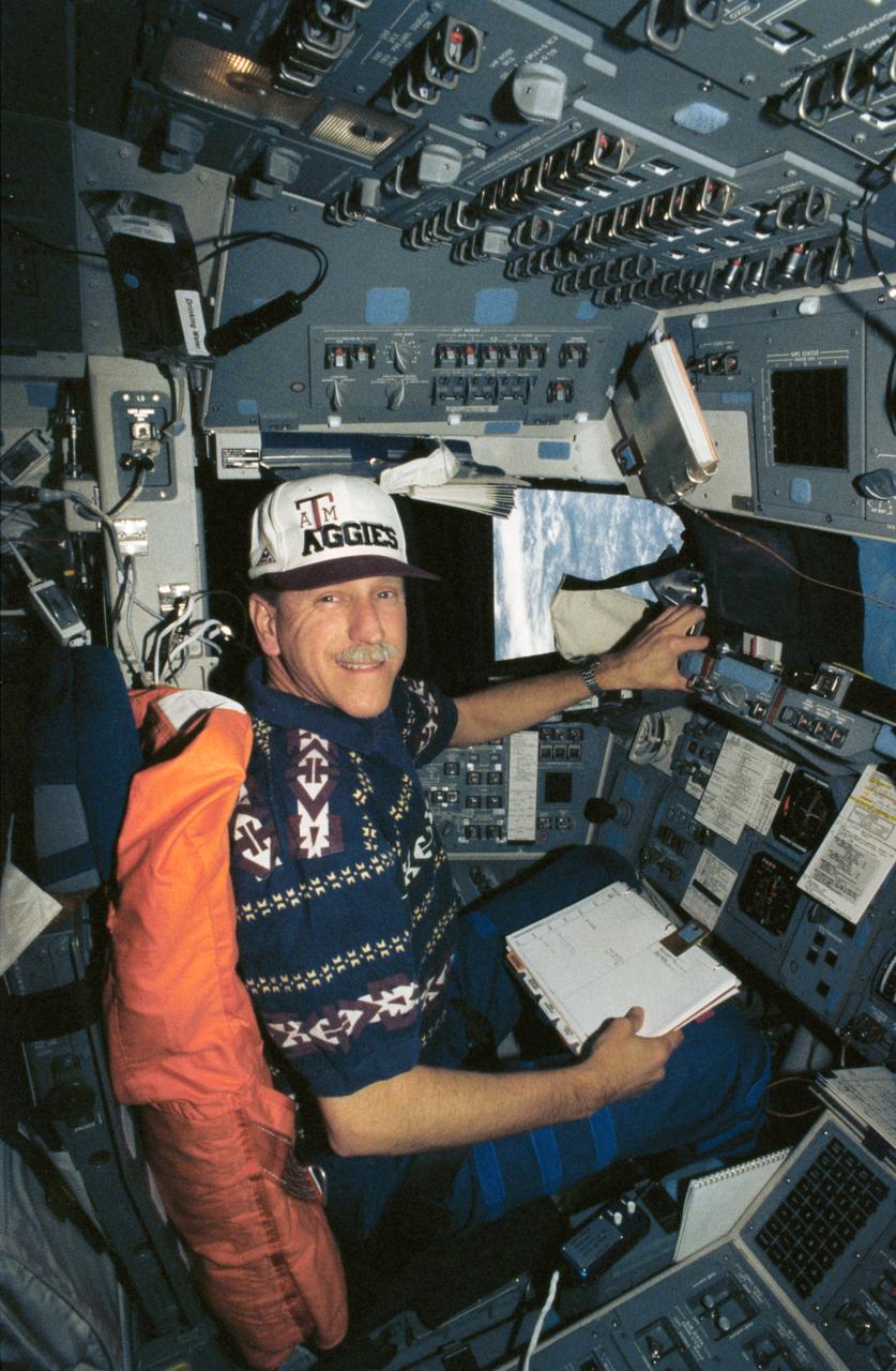 STS061-53-001 (4 Dec 1993) --- Astronaut Richard O. Covey mans the commander's station on the Space Shuttle Endeavour during flight day 3 of the eleven-day mission to service the Hubble Space Telescope (HST).  Covey wears a Texas A & M University cap as a salute to members of the training staff who have A & M connections.  The crew was busy on this day preparing for the approach and grapple operations with the HST.