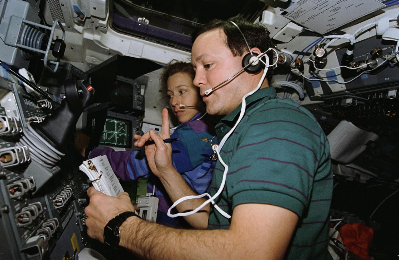STS062-05-035 (4-18 March 1994) --- This 35mm frame, photographed on the aft flight deck of the earth-orbiting Space Shuttle Columbia, captures crew activity with the Dexterous End Effector (DEE) on the Remote Manipulator System (RMS).  Astronauts Pierre J. Thuot and Marsha S. Ivins communicate with ground controllers during operations and observations with DEE.  During the 14-day mission, three of the five STS-62 crewmembers took turns operating and observing the RMS in a series of one-hour sessions.