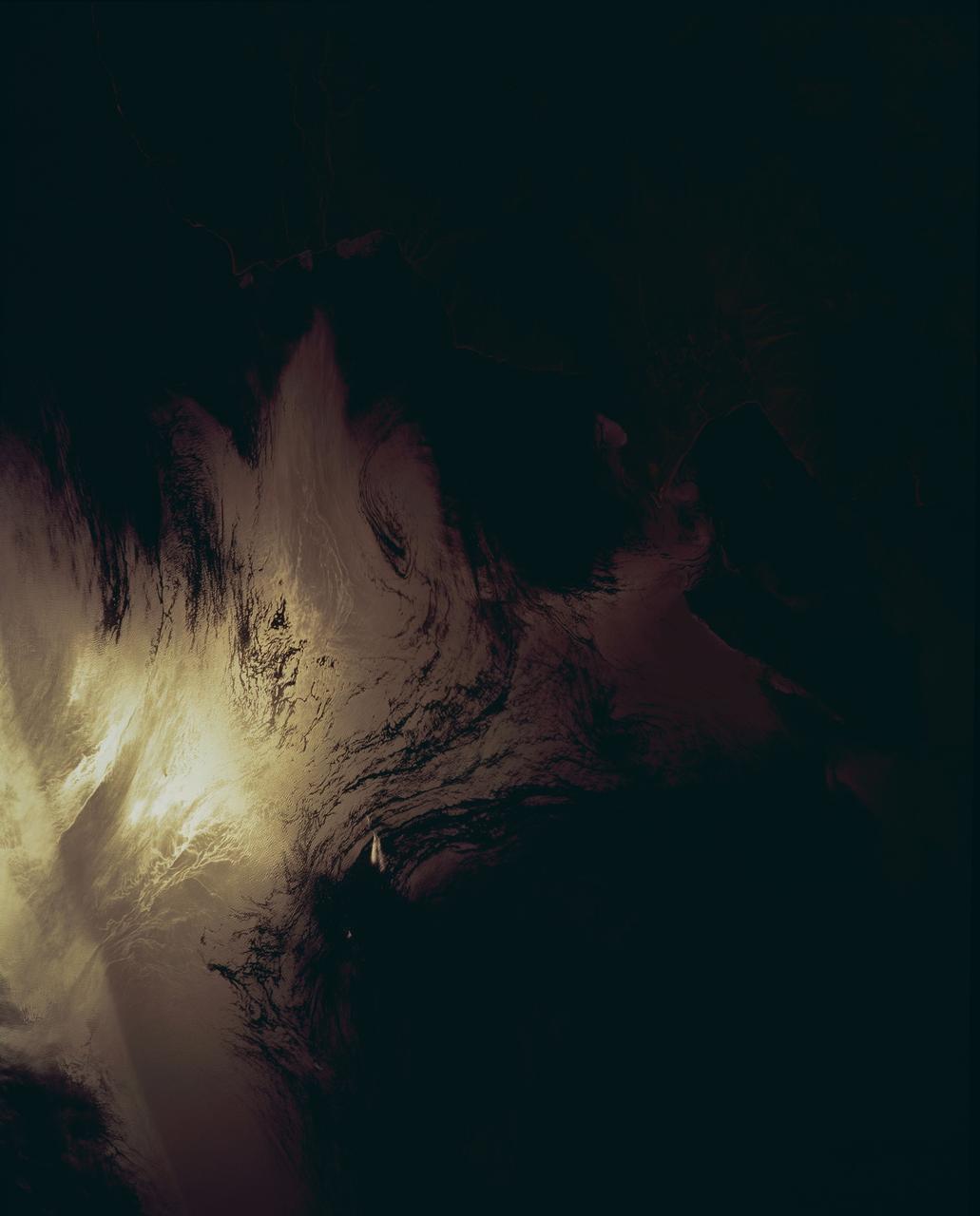 STS062-153-226 (4-18 March 1994) --- Though it did not reproduce well, this photo gives scientific information to aid in studying all types of earth's processes. It documents ocean features in the sunglint in the Gulf of California, off the Isla Cerralvo, souther Baja, California. Biological oils collect on the surface and shows current patterns, eddies and ship wakes. The small bright spot on the edge of the eddy is a ship dumping oily water from its bilges. The line in the brighter area is a light wind gust roughening the surface.