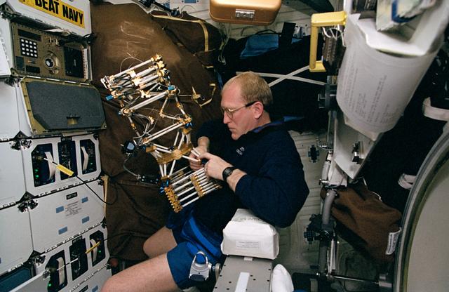 NASA image: Astronaut Sam Gemar works with Middeck O-Gravity Dynamics Experiment (MODE)