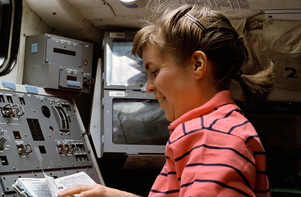 STS063-25-017 (3-11 Feb 1995) --- On the Space Shuttle Discovery's flight deck, astronaut Janice E. Voss, mission specialist, looks over a procedures list while operating the Remote Manipulator System (RMS) arm.  Voss was joined by four other NASA astronauts and a Russian cosmonaut for eight days in space, was making her second space flight.