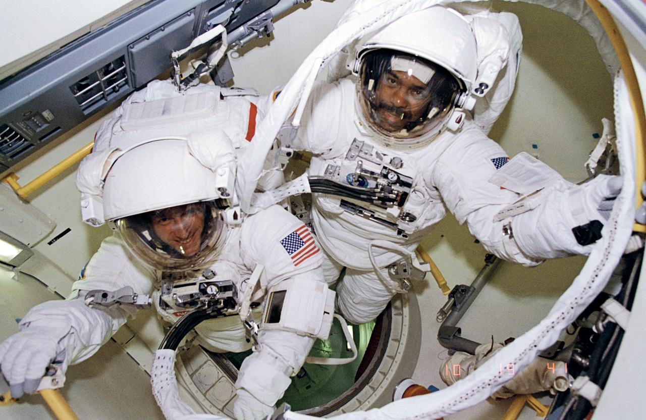 STS063-67-024 (9 Feb. 1995) --- Astronauts Bernard A. Harris Jr., STS-63 payload commander, (top right) and C. Michael Foale, mission specialist, are ready to egress airlock for an extravehicular activity (EVA).  Others onboard the space shuttle Discovery were astronauts James D. Wetherbee, mission commander; Eileen M. Collins, pilot; mission specialists Janice E. Voss, and cosmonaut Vladimir G. Titov. Photo credit: NASA