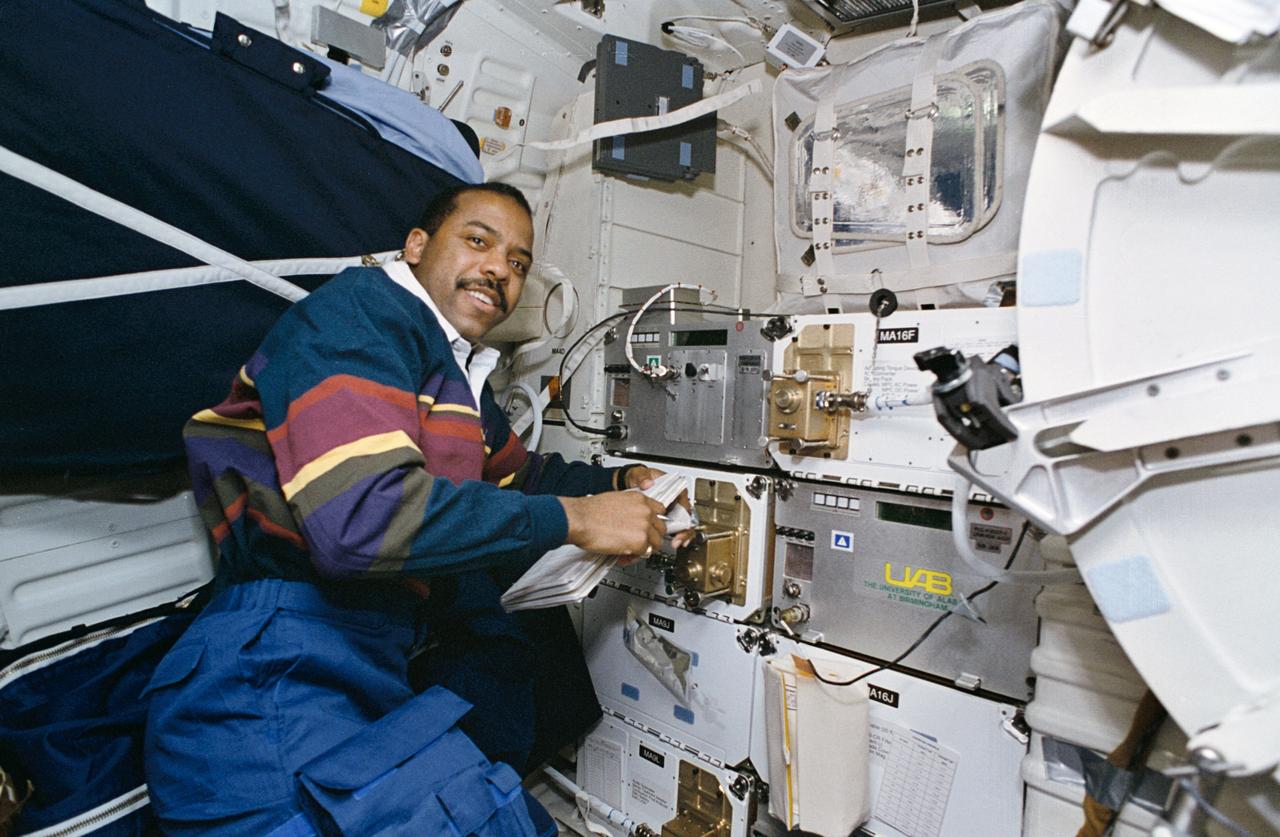 STS063-68-013 (3-11 Feb 1995) --- Astronaut Bernard A. Harris, Jr., a physician and payload commander, monitors several Spacehab-3 experiments which occupy locker space on the Space Shuttle Discovery's mid-deck. The Spacehab 3 Module is located in the cargo bay. Others onboard the Discovery were astronauts James D. Wetherbee, commander; Eileen M. Collins, pilot; mission specialists C. Michael Foale, Janice E. Voss, and Russian cosmonaut Vladimir G. Titov.