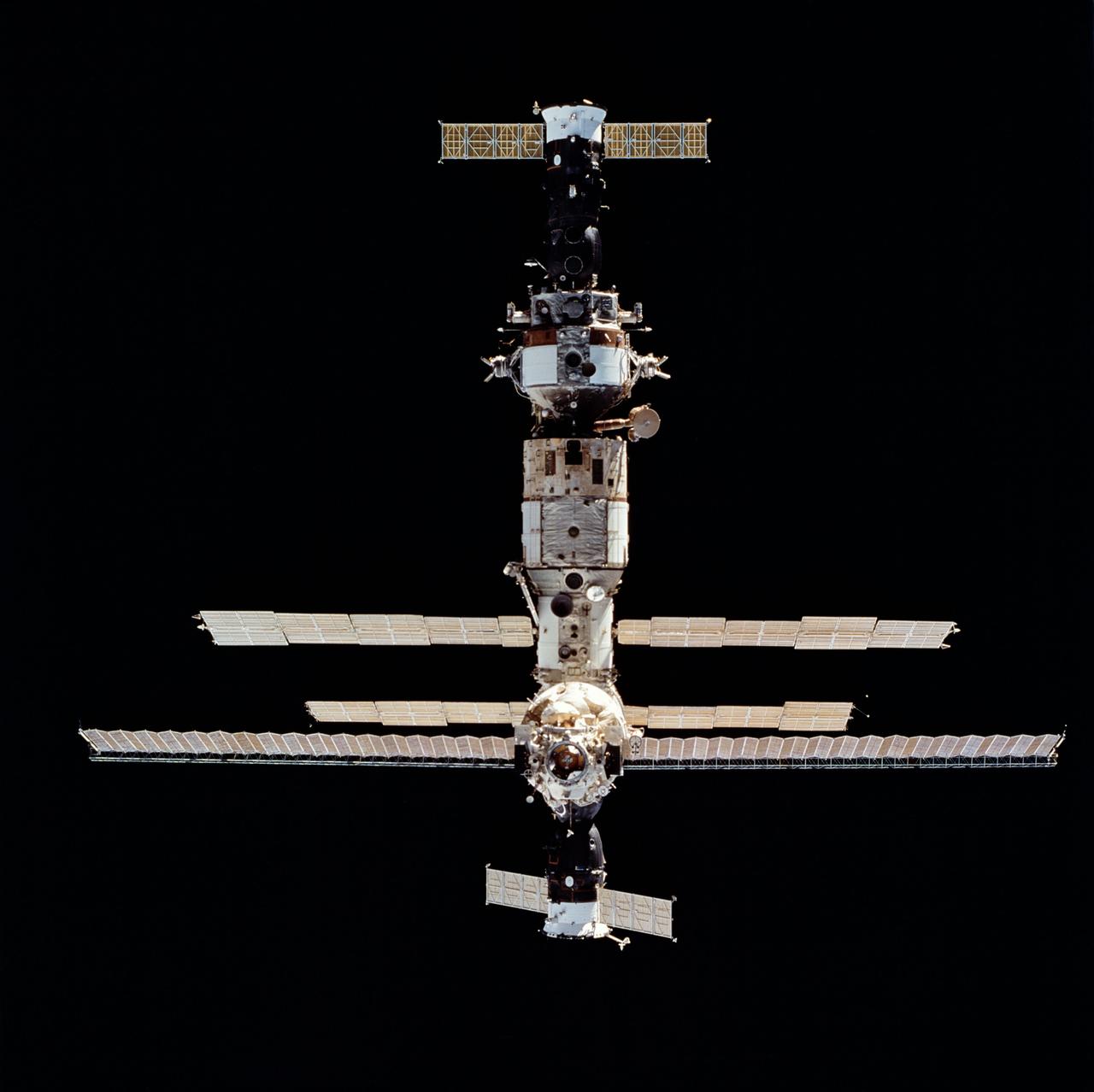 STS063-712-068 (6 Feb 1995) --- Russia's Mir Space Station during rendezvous operations with the Space Shuttle Discovery.  Docked at bottom (nearest portion where longest solar array panel is visible) is a Soyuz space vehicle.  On the opposite end is a Progress spacecraft.  This is one of 16 still photographs released by the NASA Johnson Space Center (JSC) Public Affairs Office (PAO) on February 14, 1995.  Onboard the Space Shuttle Discovery were astronauts James D. Wetherbee, mission commander; Eileen M. Collins, pilot; Bernard A. Harris, Jr., payload commander; mission specialists C. Michael Foale, Janice E. Voss, and cosmonaut Vladimir G. Titov.