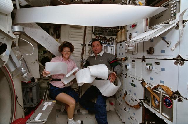 NASA image: Astronaut Collins and cosmonaut Titov organize TIPS paper messages