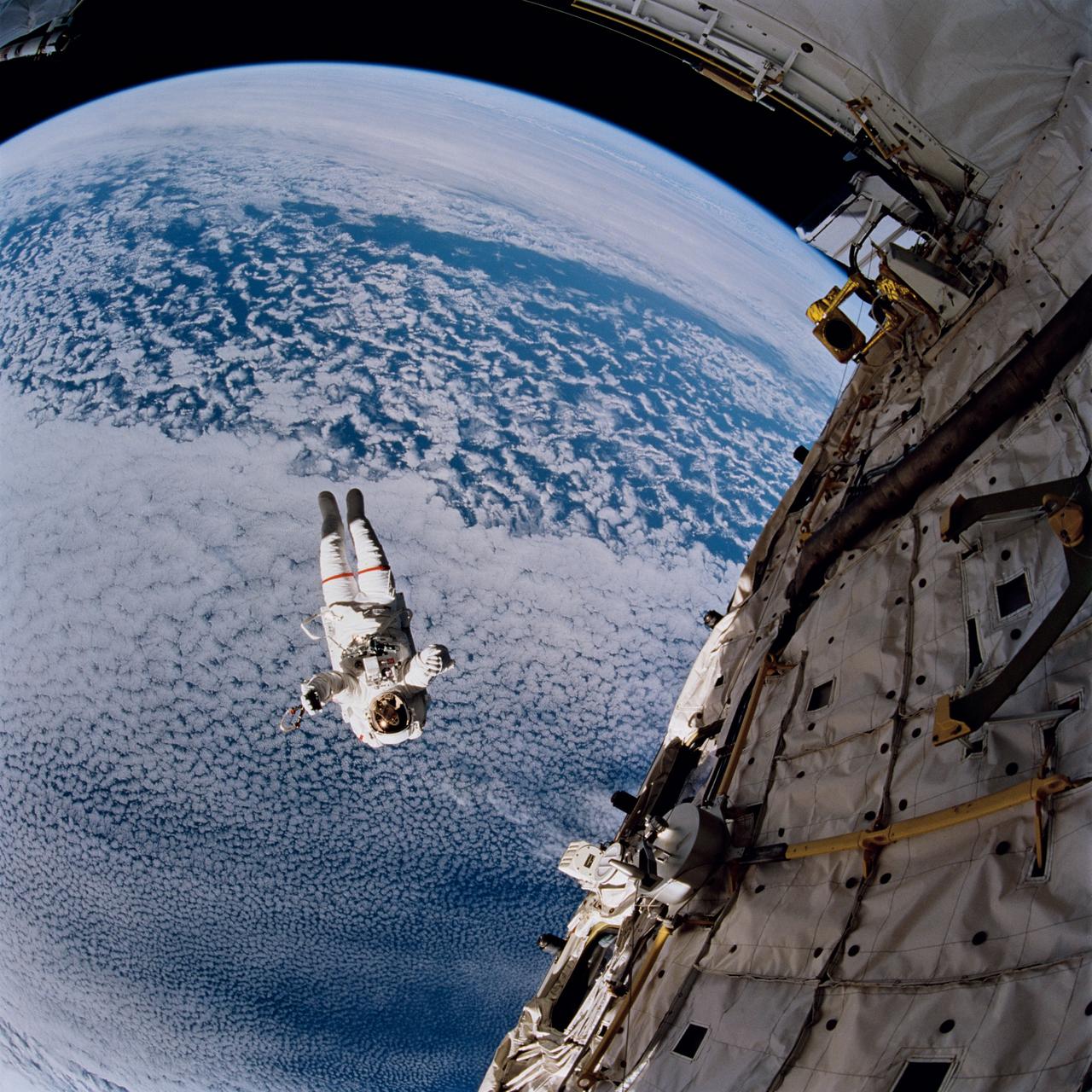 STS064-217-008 (16 Sept. 1994) --- Backdropped against the blue and white Earth, 130 nautical miles below, astronaut Mark C. Lee tests the new Simplified Aid for EVA Rescue (SAFER) system. The scene was captured with a 70mm handheld Hasselblad camera with a 30mm lens attached. Astronauts Lee and Carl J. Meade took turns using the SAFER hardware during their shared Extravehicular Activity (EVA) of Sept. 16, 1994. The test of SAFER is the first phase of a larger SAFER program whose objectives are to establish a common set of requirements for both space shuttle and space station program needs, develop a flight demonstration of SAFER, validate system performance and, finally, develop a production version of SAFER for the shuttle and station programs. Photo credit: NASA or National Aeronautics and Space Administration