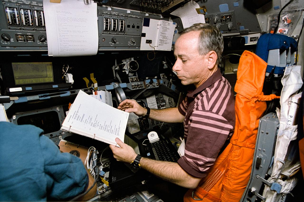 STS064-22-024 (9-20 Sept. 1994) --- With a manual and lap top computer in front of him, astronaut Carl J. Meade, STS-64 mission specialist, supports operations with the Trajectory Control Sensor (TCS) aboard the Earth-orbiting space shuttle Discovery. For this exercise, Meade temporarily mans the pilot's station on the forward flight deck.  The TCS is the work of a team of workers at NASA's Johnson Space Center. Data gathered during this flight was expected to prove valuable in designing and developing a sensor for use during the rendezvous and mating phases of orbiter missions to the space station. For this demonstration, the Shuttle Pointed Autonomous Research Tool for Astronomy 201 (SPARTAN 201) was used as the target vehicle during release and retrieval operations. Photo credit: NASA or National Aeronautics and Space Administration