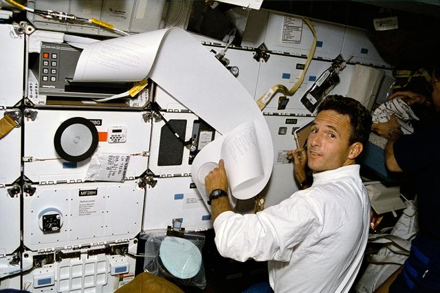 NASA image: Astronaut Jerry Linenger with sheet of TIPS correspondence