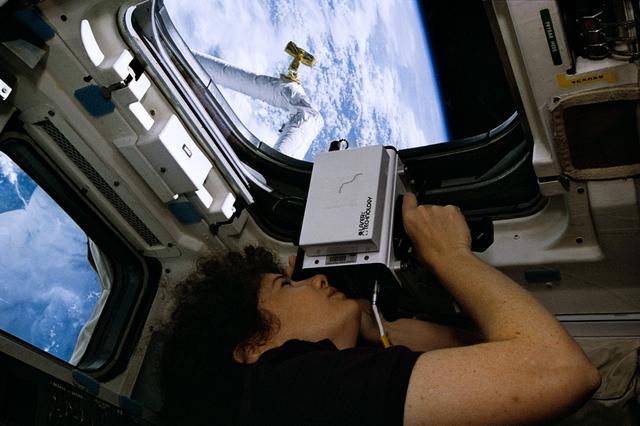 NASA image: Astronaut Susan Helms uses laser instrument during SPARTAN 201 operations