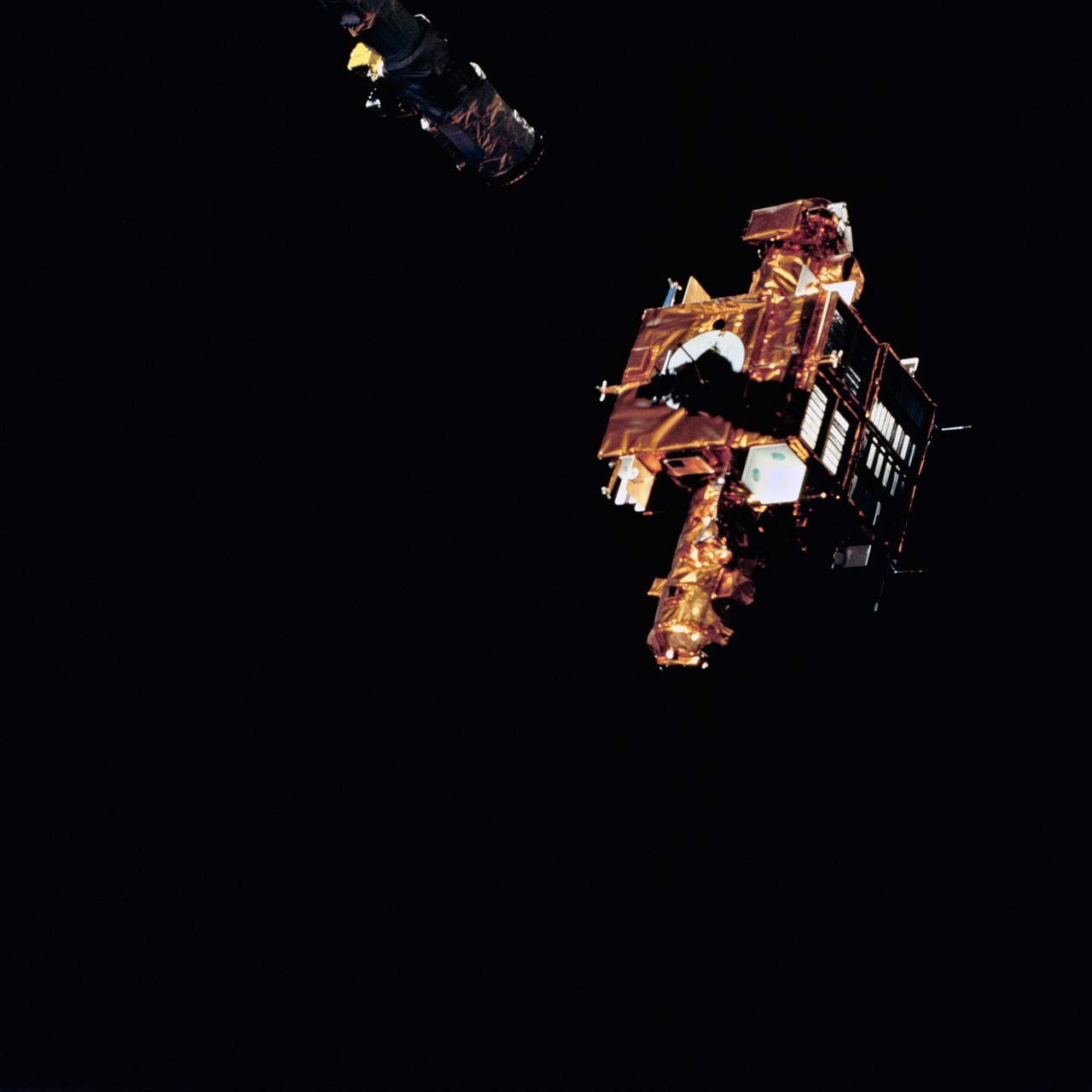 STS064-76-035 (15 Sept. 1994) --- Backdropped against the darkness of space, the Shuttle Pointed Autonomous Research Tool for Astronomy 201 (SPARTAN-201) satellite is lined up with the space shuttle Discovery's Remote Manipulator System (RMS) arm for re-capture.  The free-flying spacecraft had remained some 40 miles away from Discovery for over two days. Photo credit: NASA or National Aeronautics and Space Administration