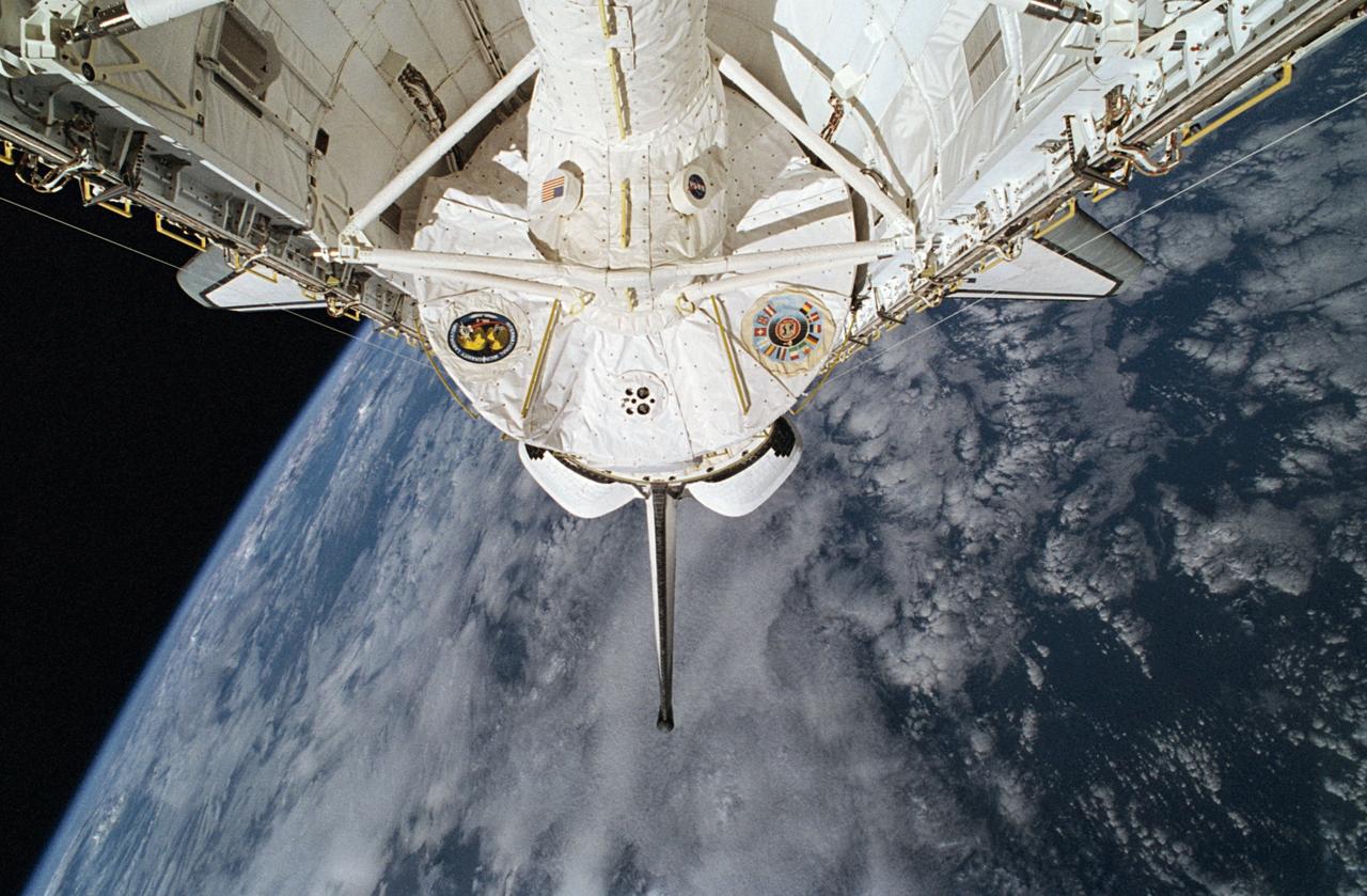 STS065-34-016 (8-23 July 1994) --- Clouds over the ocean form the backdrop for this scene of the International Microgravity Laboratory (IML-2) science module in the Space Shuttle Columbia's cargo bay during the two-week mission.  Part of the tunnel that served as passageway for the seven crew members to and from the lab is seen in center foreground.  Onboard Columbia were astronauts Robert D. Cabana, James D. Halsell, Jr., Richard J. Hieb, Carl E. Walz, Donald A. Thomas and Leroy Chiao, along with (NASDA) Japanese payload specialist Dr. Chiaki Naito-Mukai.