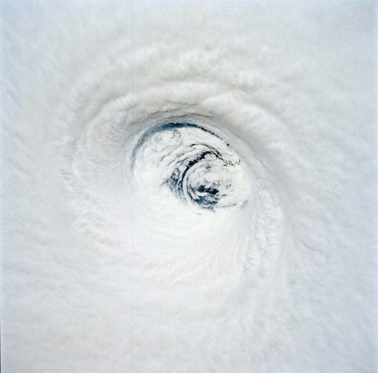 STS-65 Earth observation of Hurricane Emilia in Pacific Ocean was taken aboard Columbia, Orbiter Vehicle (OV) 102. This vertical view, photographed with a handheld 70mm camera, reveals the well-defined eye of the hurricane as it moves westerly several hundred miles southeast of the big island of Hawaii. Early in the flight the crew was able to observe the evolution of the storm and there was some concern that it might eventually head toward the Hawaiian Islands. Fortunately it did not.