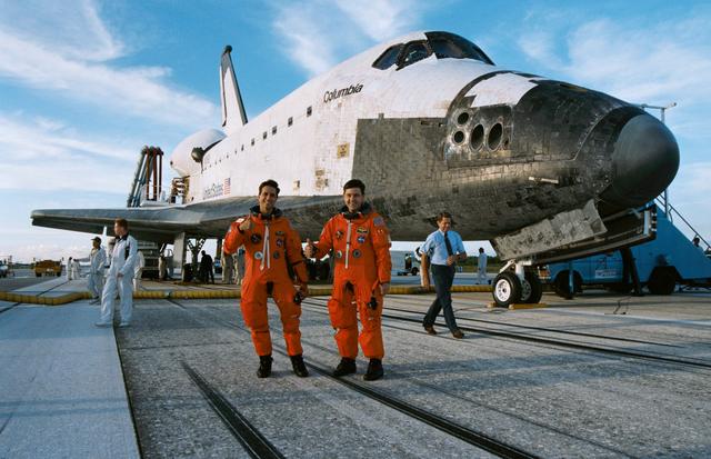NASA image: STS-65 crewmembers pose in front of OV-102 after landing at KSC's SLF