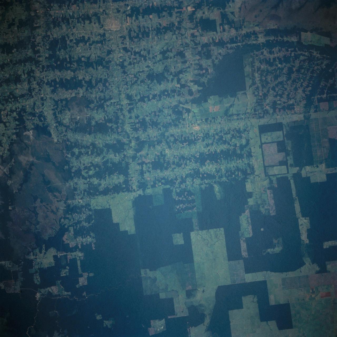 This near vertical photograph illustrates the differences in agricultural land patterns typically seen in many parts of southwestern Brazil, near the Bolivian border. The larger rectangular field patterns reflect a mature, fully developed agricultural environment. The smaller areas are less well defined and indicate new agricultural development.