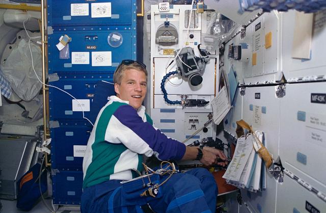 Astronaut Scott Parazynski works with PCG experiment on middeck