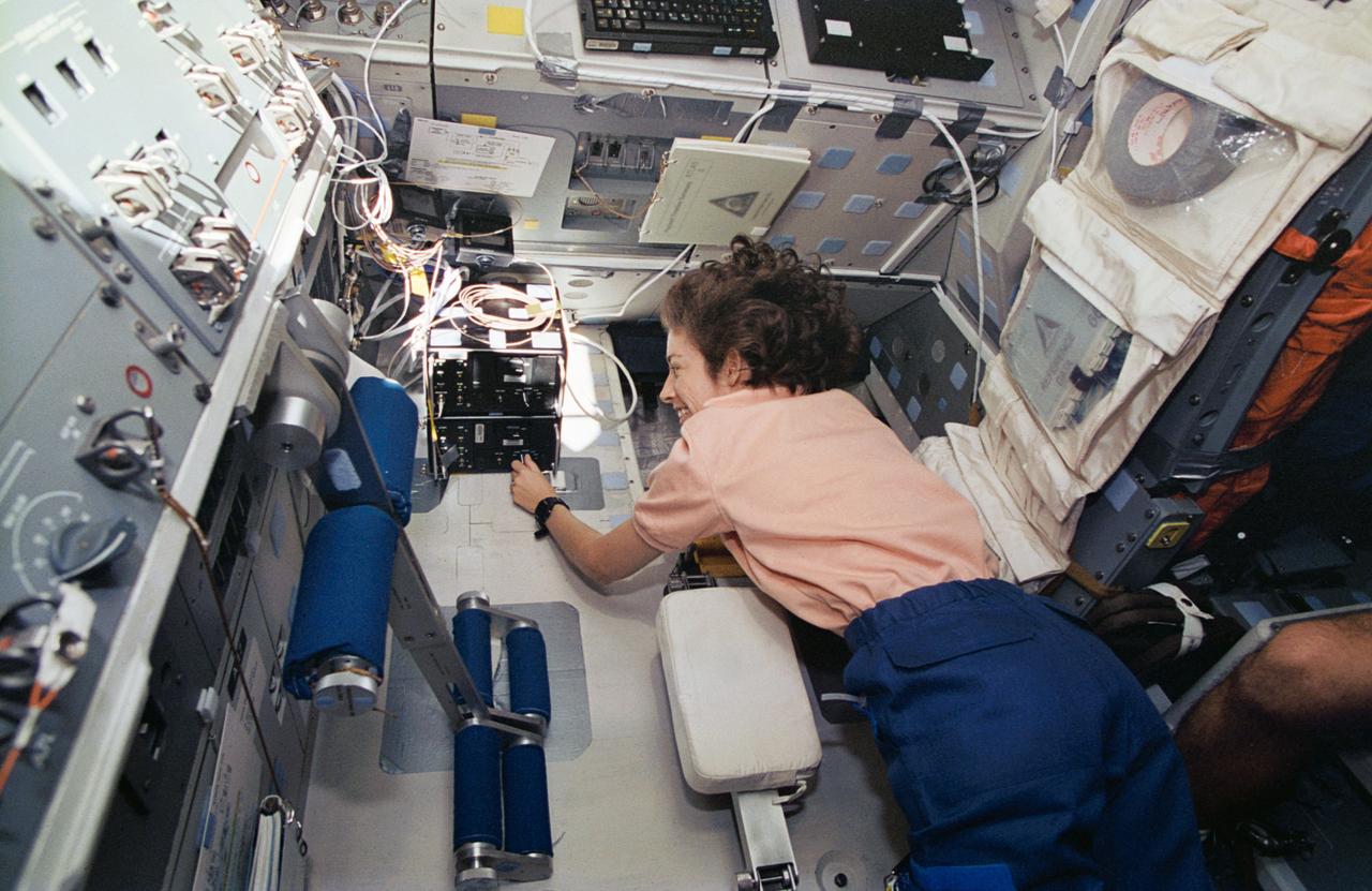 STS066-21-029 (3-14 Nov. 1994) --- On the space shuttle Atlantis' aft flight deck, astronaut Ellen Ochoa, payload commander, supports the Atmospheric Trace Molecule Spectroscopy (ATMOS) experiment with a checkout of a pair of 8mm video tape recorders.  Note Atlantis' addition of the lower body restraint device (left) used to support crew members spending long periods of stationary time at the aft flight deck.  Ochoa joined four other NASA astronauts and a European mission specialist for 11-days in space in support of the Atmospheric Laboratory for Applications and Science (ATLAS-3) mission.  Photo credit: NASA