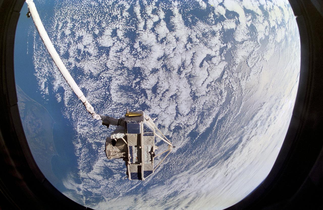 Clouds over the Atlantic Ocean serve as the backdrop for this 70mm scene of the Cryogenic Infrared Spectrometers and Telescopes for the Atmosphere (CRISTA), attached to the Shuttle Pallet System (SPAS). CRISTA-SPAS was in the grasp of the Space Shuttle Atlantis Remote Manipulator System (RMS) arm. The crew deployed the Crista-SPAS on November 4, 1994 and the tandem remained in free-flight until November 12, 1994 when it was retrieved by the Canadian-built RMS, controlled by payload commander Ellen Ochoa.