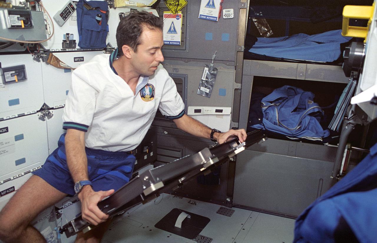 STS066-66-005 (3-14 Nov 1994) --- On the Space Shuttle Atlantis' flight deck, Jean-François Clervoy, mission specialist representing the European Space Agency (ESA), moves a platform for the recumbent seat device which was being evaluated for a future Space Shuttle flight.  The platform is just part of the mid-deck arrangement designed to accommodate crew members when the Space Shuttle docks with Russia's Mir Space Station next year.  Other crew members onboard Atlantis for the 11-day day Atmospheric Laboratory for Applications and Science (ATLAS-3) mission were astronauts Donald R. McMonagle, Curtis L. Brown, Jr., Ellen Ochoa, Scott E. Parazynski and Joseph R. Tanner.