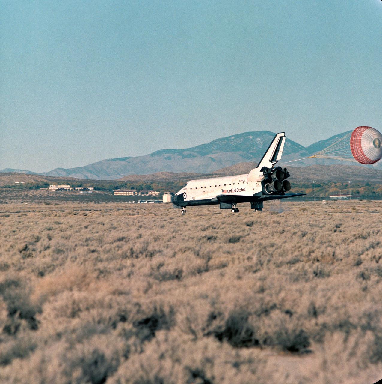 STS066-S-039 (14 November 1994) --- The drag chute is fully deployed as the Space Shuttle Atlantis heads toward a stop at Edwards Air Force Base in southern California, ending a successful 10 day, 22 hour and 34 minute space mission.  Landing occurred at 7:34 a.m. (PST), November 14, 1994.  Onboard were astronauts Donald R. McMonagle, commander; Curtis L. Brown, Jr., pilot; Ellen S. Ochoa, payload commander; Scott E. Parazynski and Joseph R. Tanner, both mission specialists, along with European Space Agency (ESA) mission specialist Jean-Francois Clervoy.  The crew supported the Atmospheric Laboratory for Applications and Science (ATLAS-3) mission.