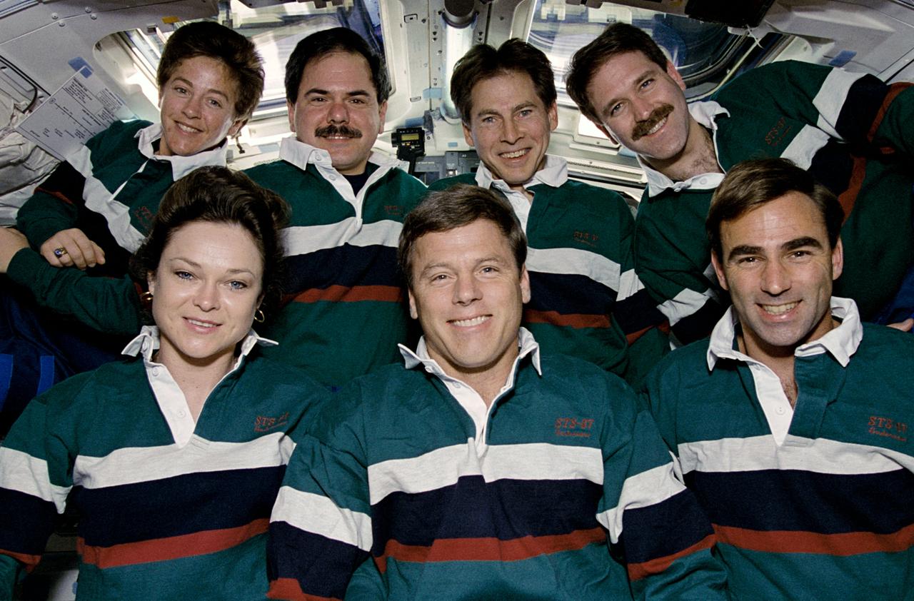 The STS-67/ASTRO-2 crew members pose for their traditional inflight portrait on the aft flight deck of the Earth orbiting Space Shuttle Endeavour. Left to right in the front are astronauts Tamara E. Jernigan, payload commander; Steven S. Oswald, mission commander; and William G. Gregory, pilot. Left to right on the back row are astronaut Wendy B. Lawrence, flight engineer; payload specialists Ronald A. Parise and Samuel T. Durrance; and John M. Grunsfeld, mission specialist.