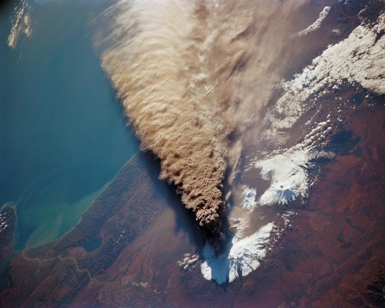 STS068-150-045 (30 September 1994) --- (Kliuchevskoi Volcano) The major eruption that began September 30, 1994 (launch day) got almost immediate coverage by the astronauts aboard the Space Shuttle Endeavour. The eruption cloud reached 60,000 feet above sea level, and the winds carried ash as far as 640 miles southeast from the volcano into the North Pacific air routes. This picture was made with a large format Linhof camera.  While astronauts used handheld camera's to keep up with the Kamchatka event, instruments in the cargo bay of Endeavour recorded data to support the Space Radar Laboratory (SRL-2) mission.