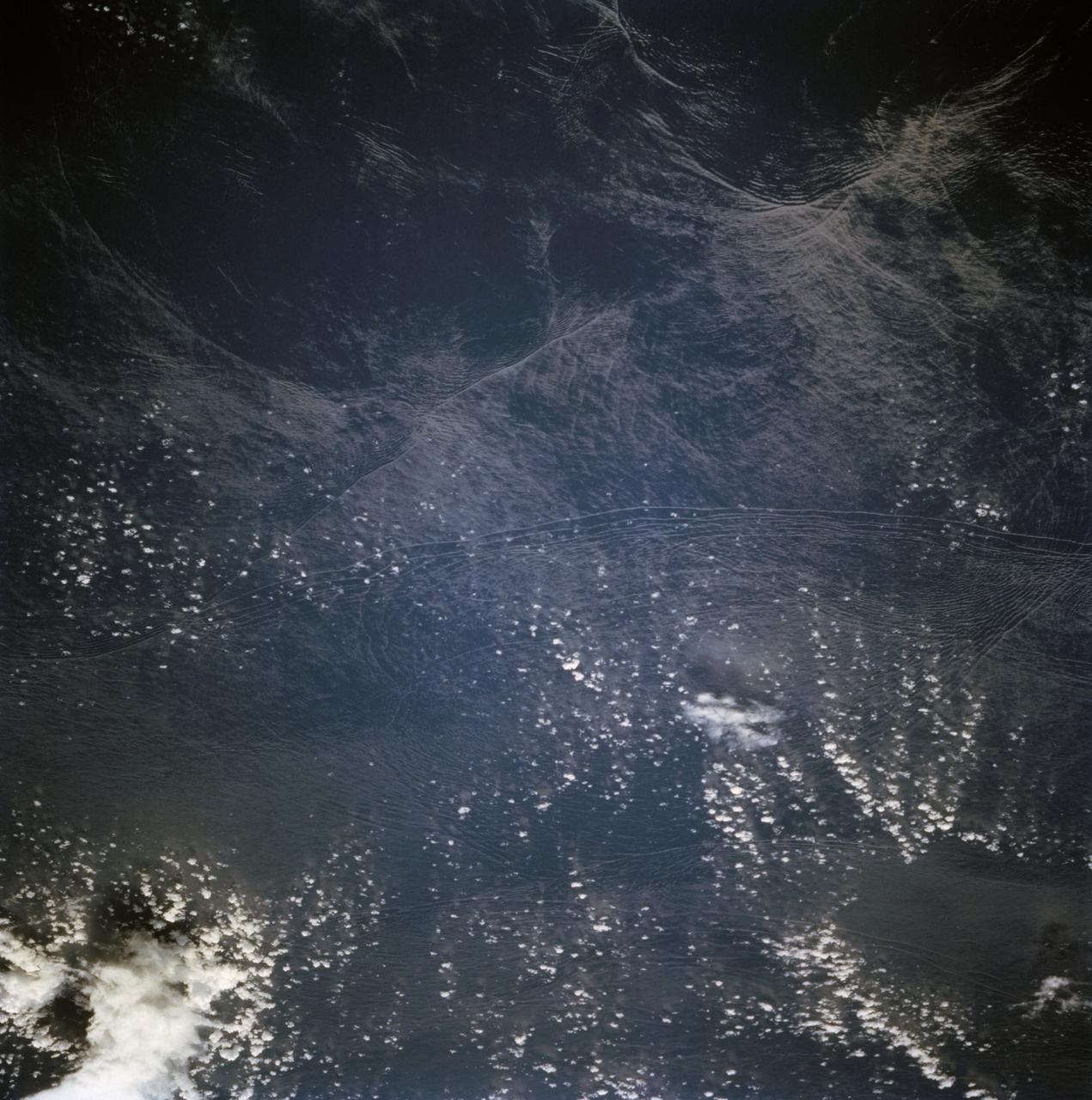 STS068-236-044 (30 September-11 October 1994) --- These internal waves in the Andaman Sea, west of Burma, were photographed from 115 nautical miles above Earth by the crew of the Space Shuttle Endeavour during the Space Radar Laboratory 2 (SRL-2) mission.  The internal waves smooth out some of the capillary waves at the surface in bands and travel along the density discontinuity at the bottom of the mixed layer depth. There is little evidence of the internal waves at the surface. They are visible in the Space Shuttle photography because of sunglint, which reflects off the water.