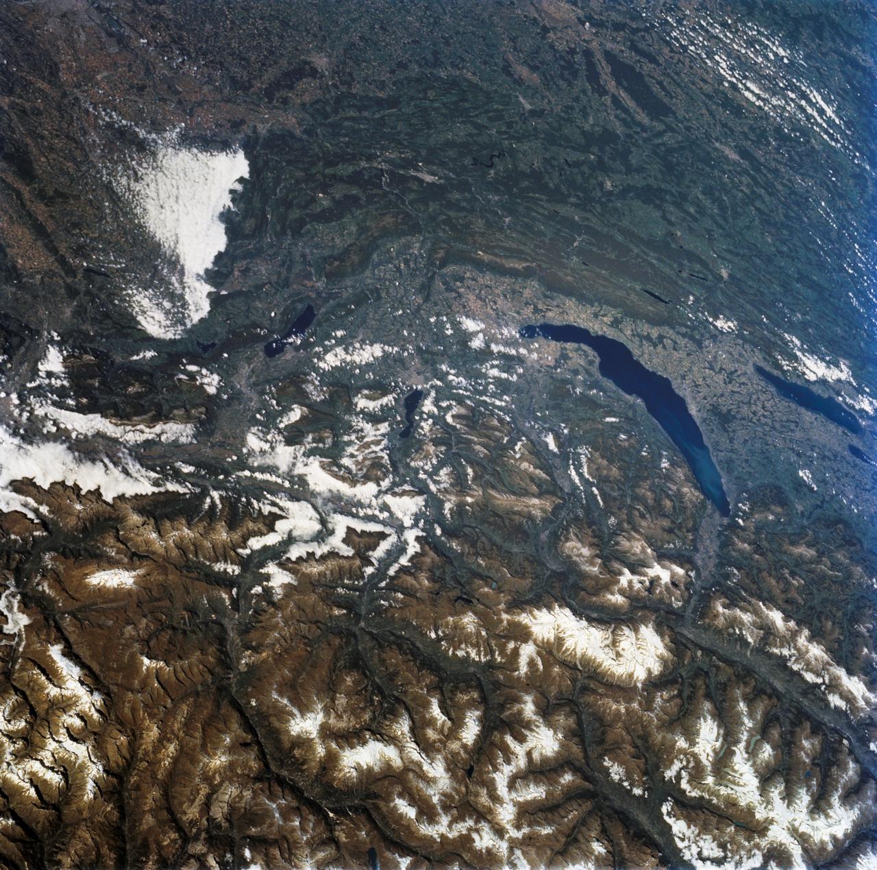STS068-243-076 (30 September-11 October 1994) --- Parts of the Swiss Cantons of Vaud and Valois, the French province of Chablis and parts of northwestern Italy are seen in this widely stretching image photographed from the Space Shuttle Endeavour. Pennine Alps, said to have been created 50 million years ago, have been reshaped by glaciers during Pleistocene. The glaciers created the wide valley of the Rhone River by scourting a pre-existing seam. The fertile Swiss Plateau runs northwest from the shore of Lake Geneva and is visible in lower left. The Franco-Swiss border is located in the center of the lake and follows a mountain divide east of Rhone Valley.  Italy lies south of the Rhone.
