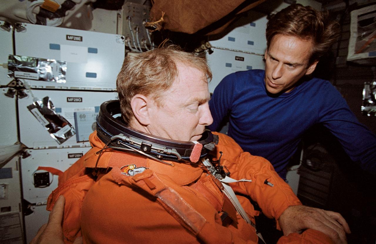 STS069-343-014 (18 September 1995) --- Astronaut David M. Walker, mission commander, gets a hand from astronaut Michael L. Gernhardt as he gets into the partial-pressure launch and entry suit in preparation for landing. STS-69 and the Space Shuttle Endeavour, with a five-member crew, launched on September 7, 1995, from the Kennedy Space Center (KSC). The multifaceted mission ended September 18, 1995, with a successful landing on Runway 33 at KSC.