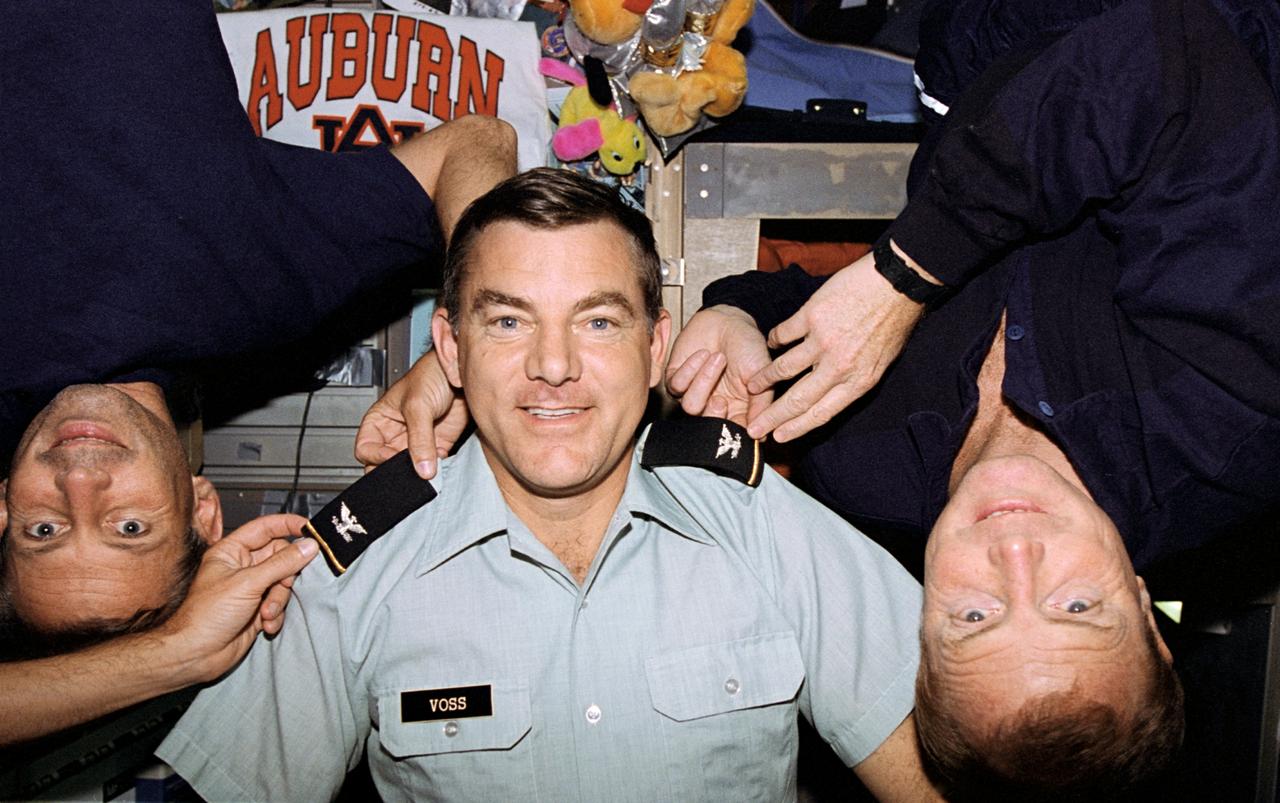 STS069-347-013 (7-18 September 1995) --- Upon the announcement of his new status as a Colonel, selectee, Lieutenant Colonel James S. Voss (United States Army), gets a preview of the new rank with the aid of fellow crewmembers. They are astronauts David M. Walker (right) and Kenneth D. Cockrell, commander and pilot, respectively. Mission specialist Voss, payload commander, made his third flight in space. The Space Shuttle Endeavour, with a five-member crew, launched on September 7, 1995, from the Kennedy Space Center (KSC). The mission ended September 18, 1995, with a successful landing on Runway 33 at KSC.