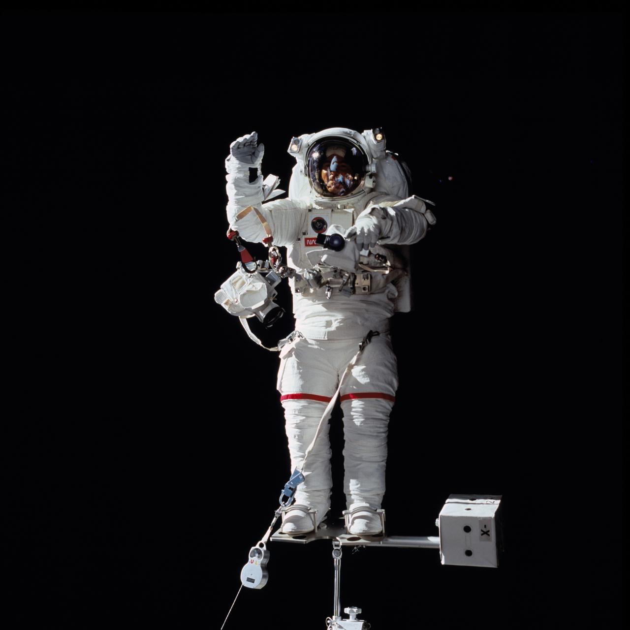 STS069-714-063 (16 September 1995) --- Astronaut James S. Voss, payload commander, is pictured during the September 16, 1995, Extravehicular Activity (EVA) which was conducted in and around Space Shuttle Endeavour's cargo bay. Voss, whose visor reflects Endeavour's forward section, was standing on a mobile foot restraint attached to the arm of the Remote Manipulator System (RMS).  As evidenced by the thin white cable, Voss was tethered to the end of the RMS as well.  Evaluations for Space Station-era tools and various elements of the space suits were performed by Voss and his space walking crewmate, astronaut Michael L. Gernhardt, mission specialist.