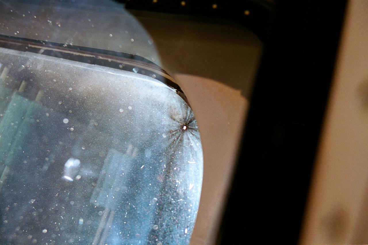 STS070-309-026 (13-22 JULY 1995) --- A close-up view of the space shuttle Discovery?s window number 6, on the forward starboard side, nearest the pilot?s station.  A small impact in the window, about 1/16 inch in size, is clearly seen in the corner.  Crew members told a August 11, 1995, gathering of Johnson Space Center (JSC) employees that a small piece of debris apparently struck the window during Discovery?s wing velocity vector mode.  It was noticed when the astronauts awoke from their sleep period.  Though watched closely during the remainder of the mission, the impact never caused a major concern.