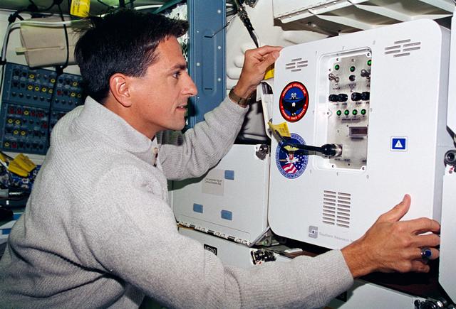 NASA image: Thomas checks the condition of the MIS-B middeck locker experiment