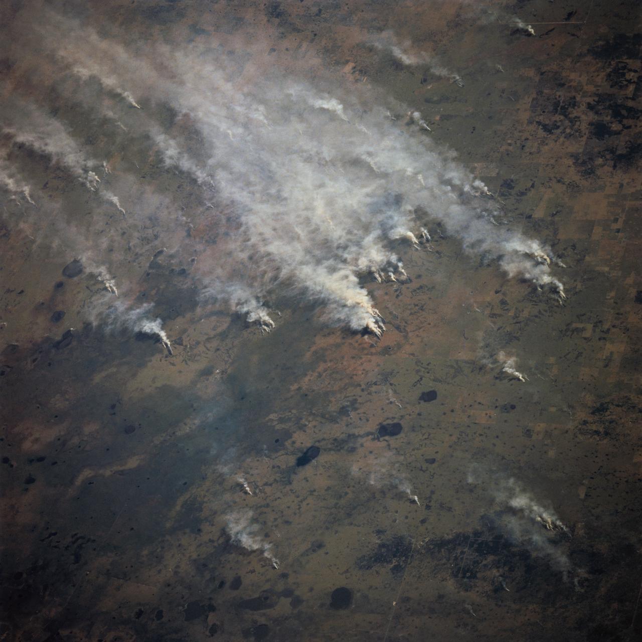 STS070-717-027 (13-22 JULY 1995) --- Easterly winds from the Mozambique Channel blow the smoke from many large fires in southern Mozambique inland. Neighboring views showed the smoke moving over and around the Chimanimani Mountains, into Zimbabwe on the African plateau. Winter is the dry season in southern Africa and fires are set to hasten the greening of the grass shoots for cattle grazing.