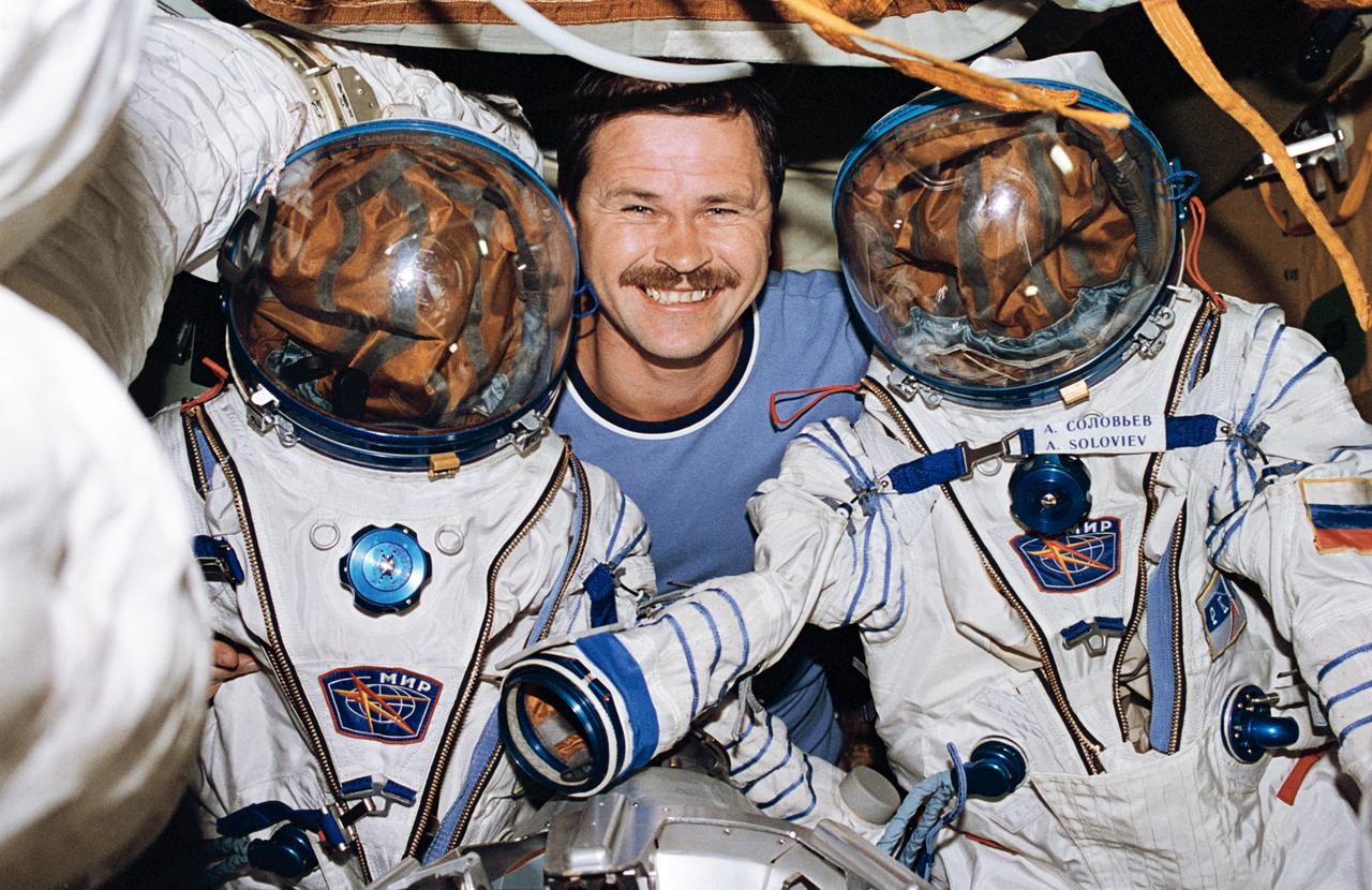STS071-104-029 (27 June-7 July 1995) --- Cosmonaut Nikolai M. Budarin, Mir-19 flight engineer, is pictured on Russia's Mir Space Station with two Russian space suits. These are for Intravehicular (IVA) wear and are not the suits designed for Extravehicular Activity (EVA). Budarin remained aboard Mir with cosmonaut Anatoly Y. Solovyev, Mir-19 commander, when the three Mir-18 crewmembers and the five STS-71 astronauts later undocked the space shuttle Atlantis from Mir and returned to Earth.