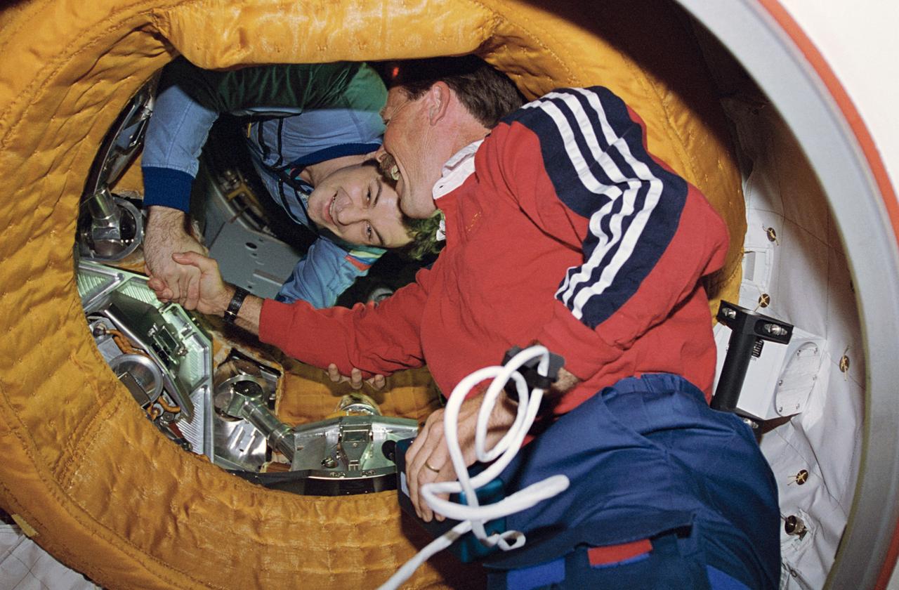 STS071-118-004 (29 June 1995) --- Astronaut Robert L. Gibson, STS-71 commander, shakes the hand of cosmonaut Vladimir N. Dezhurov, Mir-18 commander. The historic handshake took place two and half weeks prior to the 20th anniversary of a similar in-space greeting between cosmonauts and astronauts participating in the Apollo-Soyuz Test Project (ASTP). On July 17, 1975, astronaut Thomas P. Stafford, NASA's ASTP commander, greeted his counterpart, Aleksey A. Leonov in a docking tunnel linking the Soyuz and Apollo spacecraft.