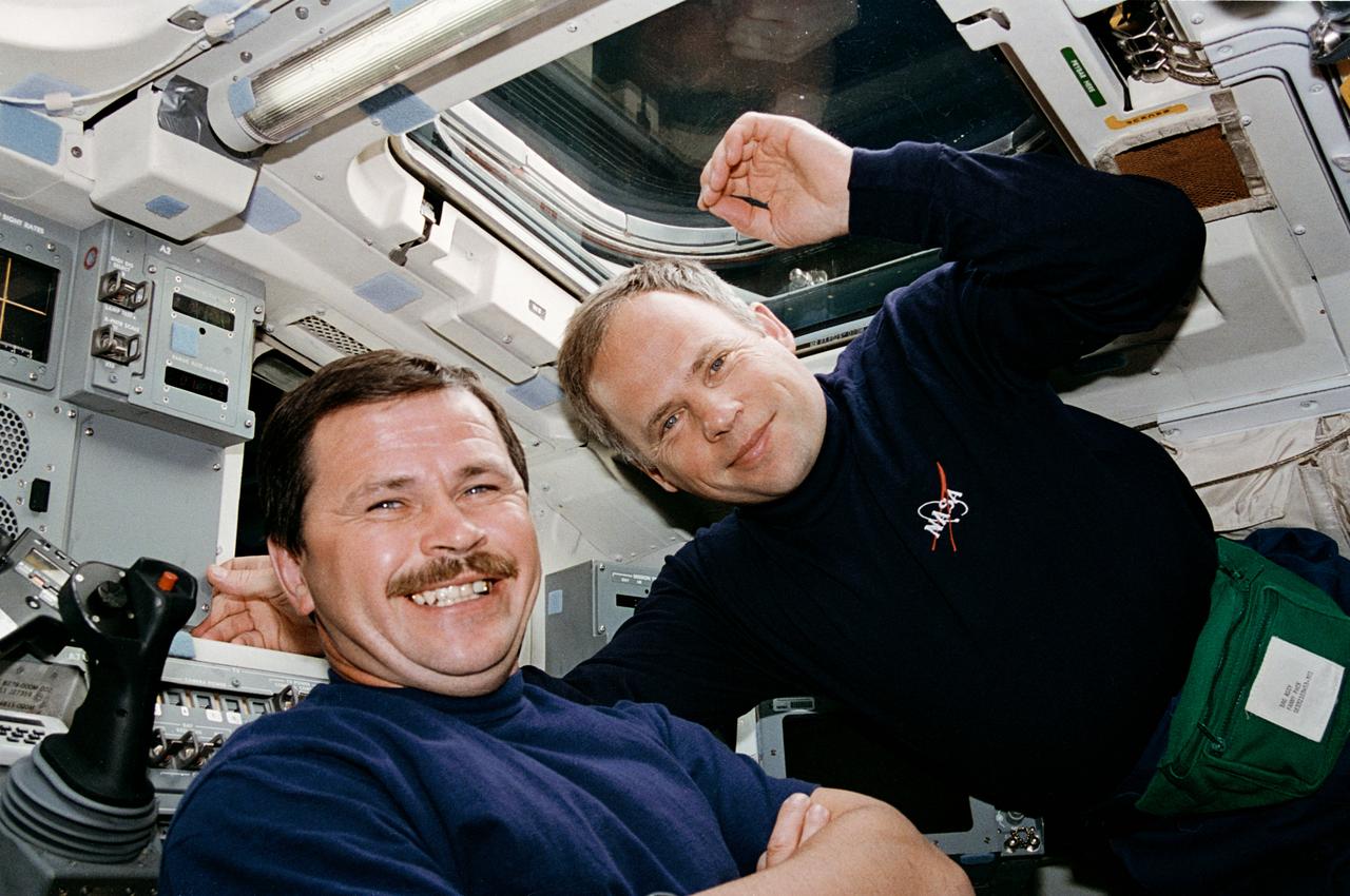 STS071-310-001 (27 June-7 July 1995) --- Cosmonauts Nikolai M. Budarin (left) and Anatoly Y. Solovyev are seen on the space shuttle Atlantis' flight deck. Not long after this picture was made, the two Mir-19 crew members bade farewell to two other cosmonauts and six NASA astronauts who returned to Earth aboard Atlantis. Solovyev, Mir-19 commander, and Budarin, Mir-19 flight engineer, will stay onboard Russia's Mir Space Station for continuing research.